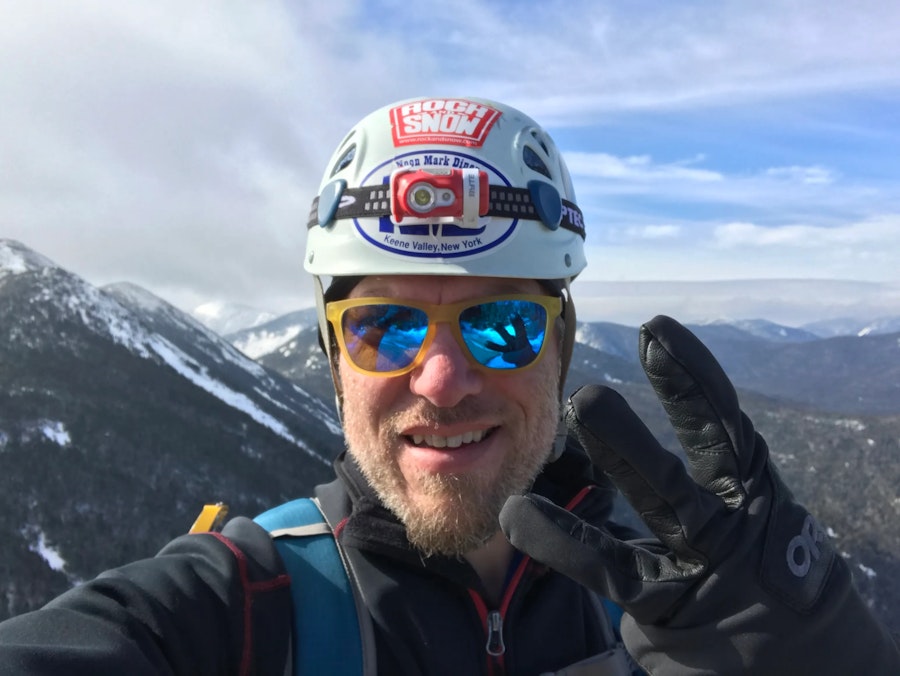 The author, posing on top of a mountain with 3 fingers held up.