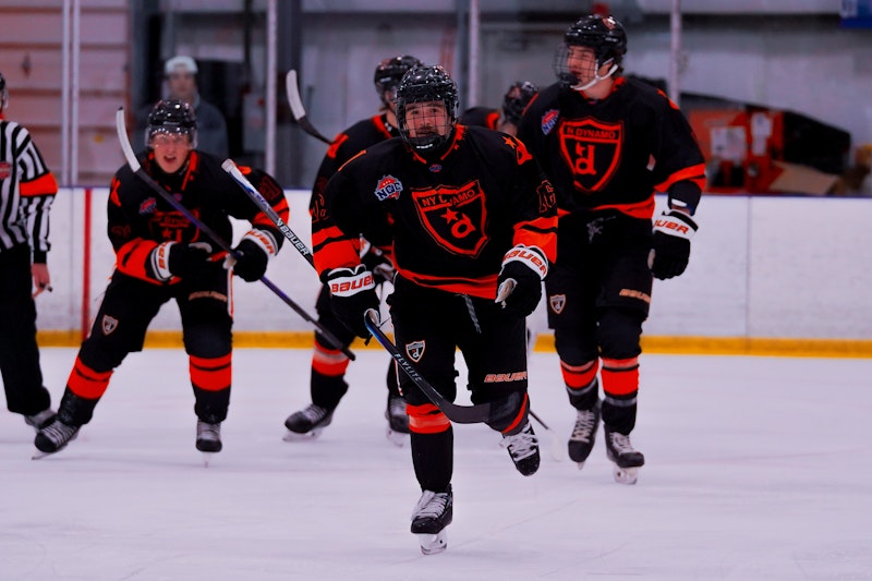 NY Dynamo players in a goal celebration huddle