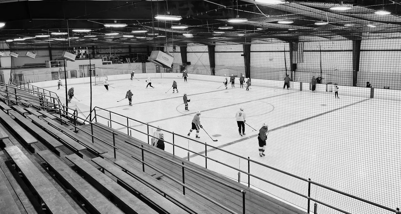 Hockey players skating on a rink during a practice session.