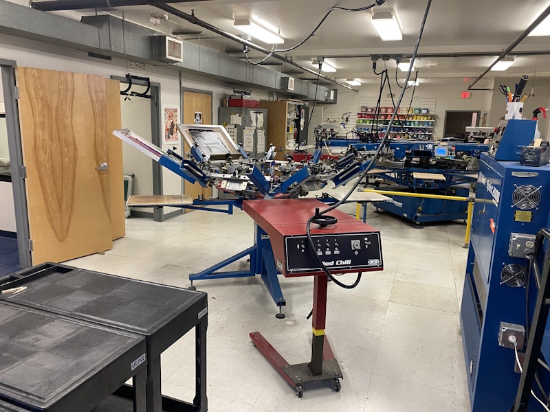 An industrial screen printing machine in the East Coast Printers shop.